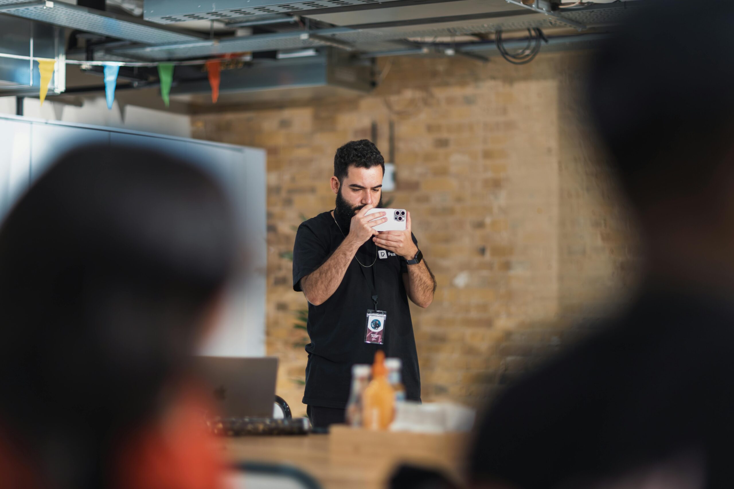 Professional event photographer capturing key moments at an indoor corporate event, ensuring high-quality coverage.